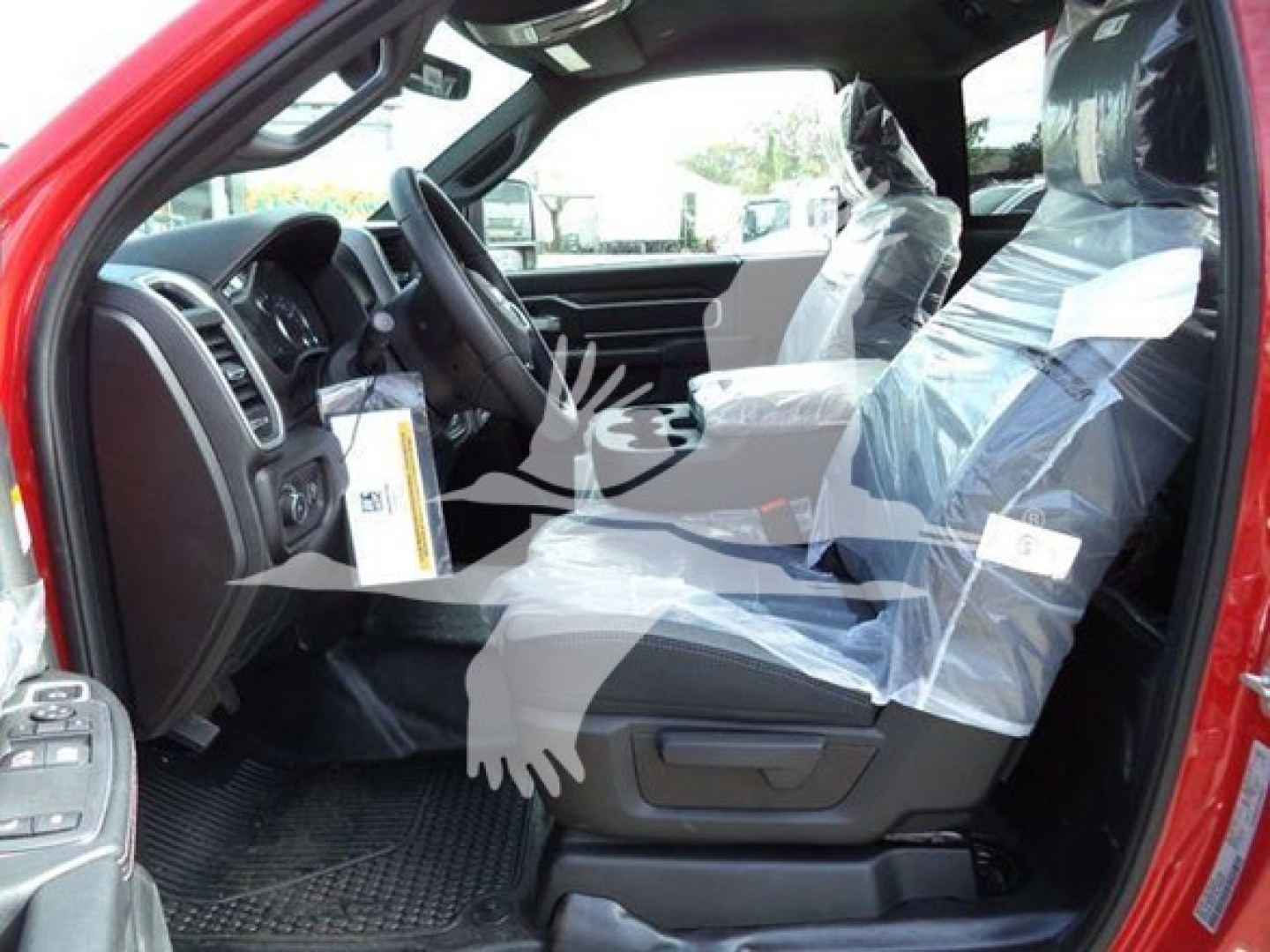 Ram 4500 SLT interior view showing front seats wrapped in plastic and dashboard area.