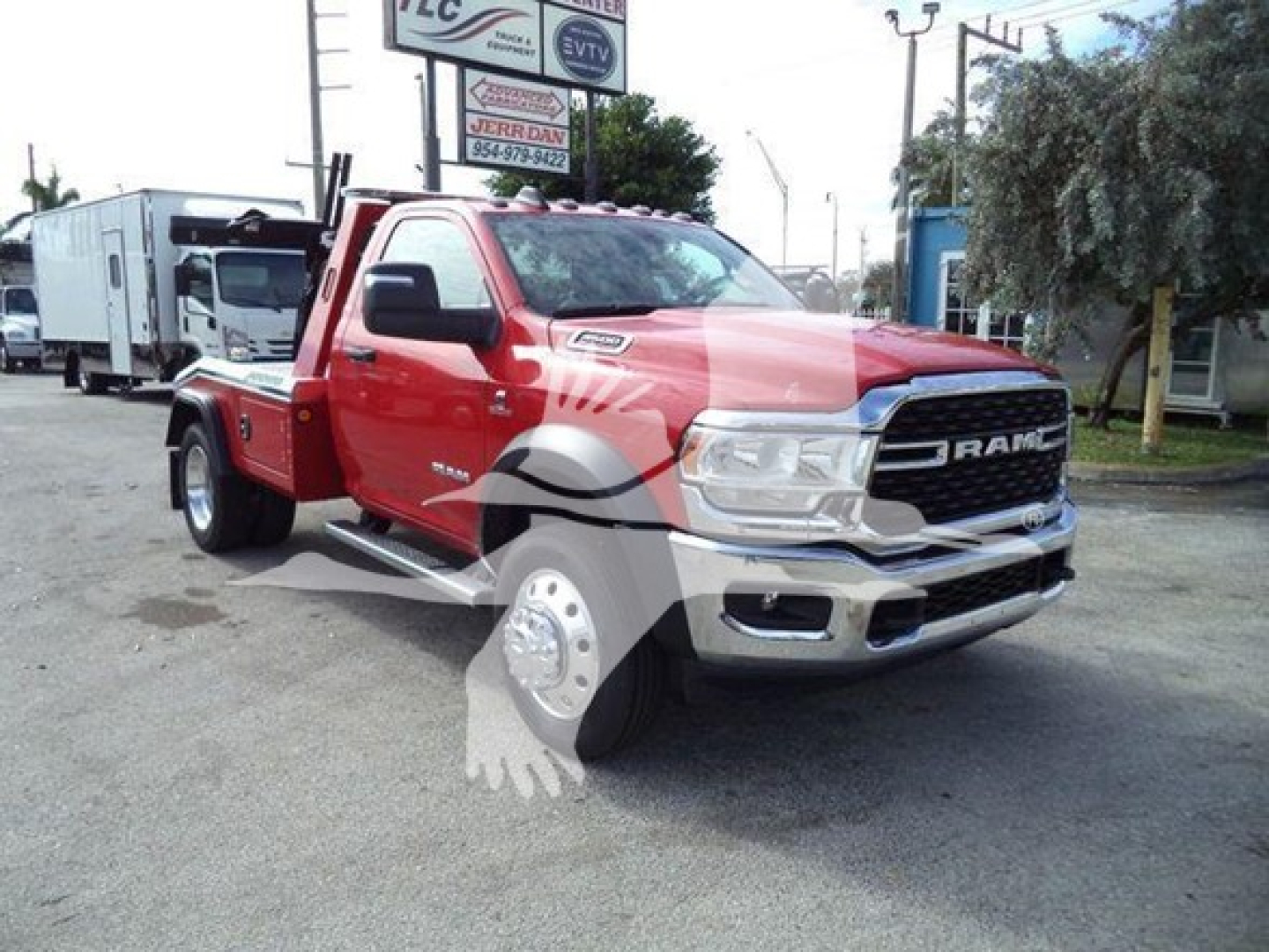 Ram 4500 tow truck front-quarter view showing chrome grille, RAM lettering, dual headlights, red body, empty Flatbed with winch mount.