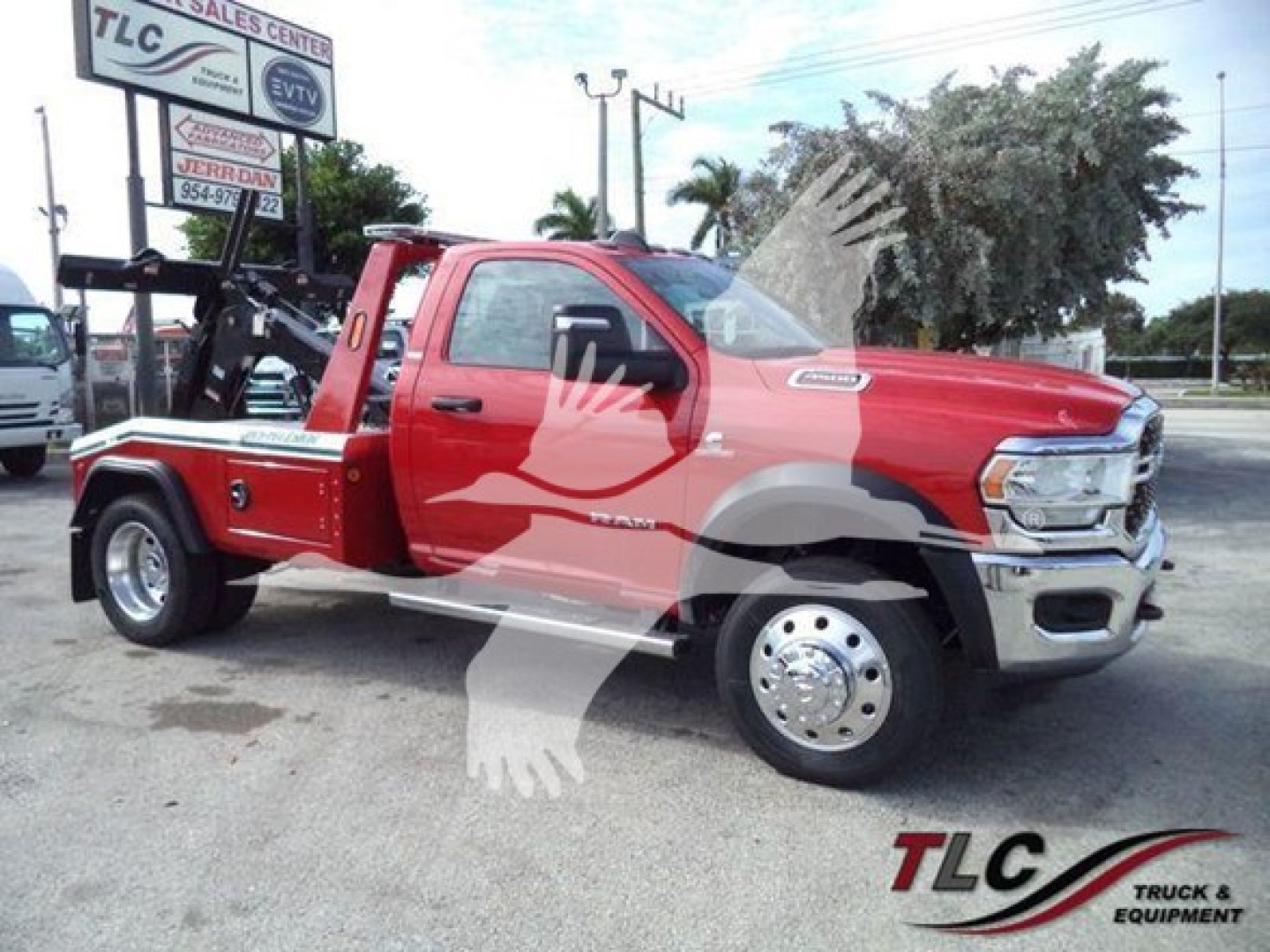 Ram 4500 tow truck with winch equipment on a red crew cab chassis, side view showing banners and TLC logo in background.