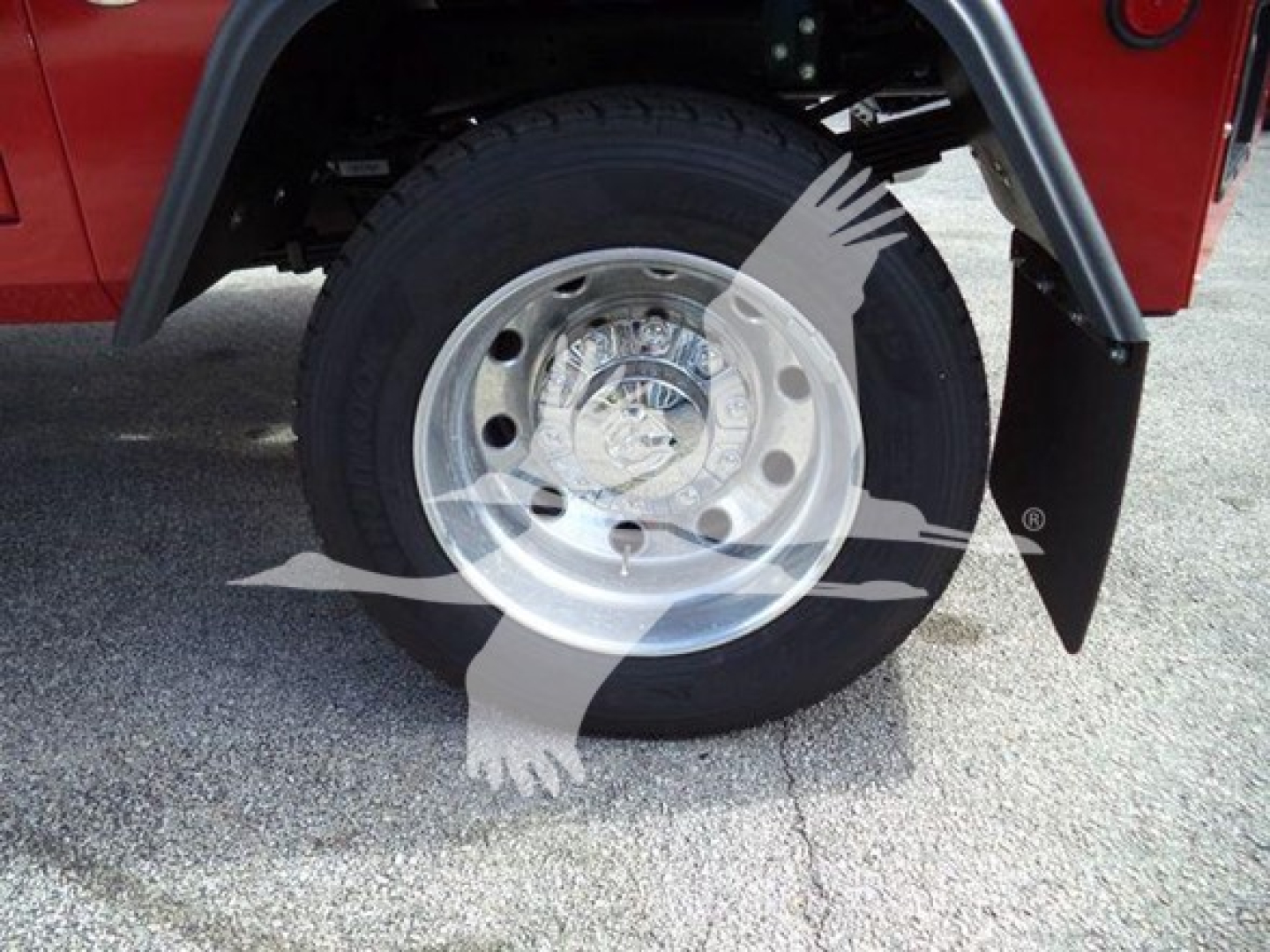 Wheel and tire of a Ram 4500 truck with chrome hubcap; partial fender and mud flap visible.