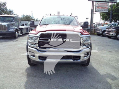 Front view of a red 2024 Ram 4500 SLT truck in a dealership lot with RAM grille emblem and chrome bumper.