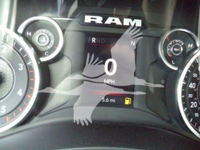 Ram instrument cluster showing RAM logo, gear indicator PRND, speedometer reading 0 mph, odometer 5.6 miles, fuel icon, warning light, and dials.