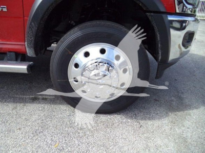 Truck wheel and chrome hubcap shown in vehicle fender area
