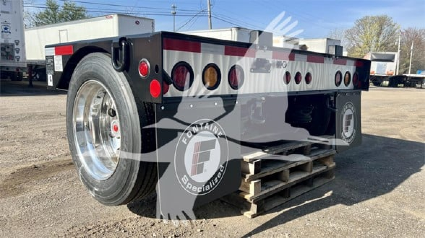 Fontaine Renegade flip axle trailer in new condition showing rear left angle with dual wheels and rear deck; logo watermarked across image.