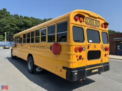 School bus in yellow showing rear and right side, 'SCHOOL BUS' sign, number 374, rear bumper and round taillights, blue sky, text along side reading Central School District, used bus.