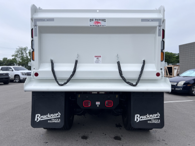 Back view of a 2027 Mack GR64F dump truck showing rear dump bed and dual mud flaps labeled Bruckner's Truck & Equipment.