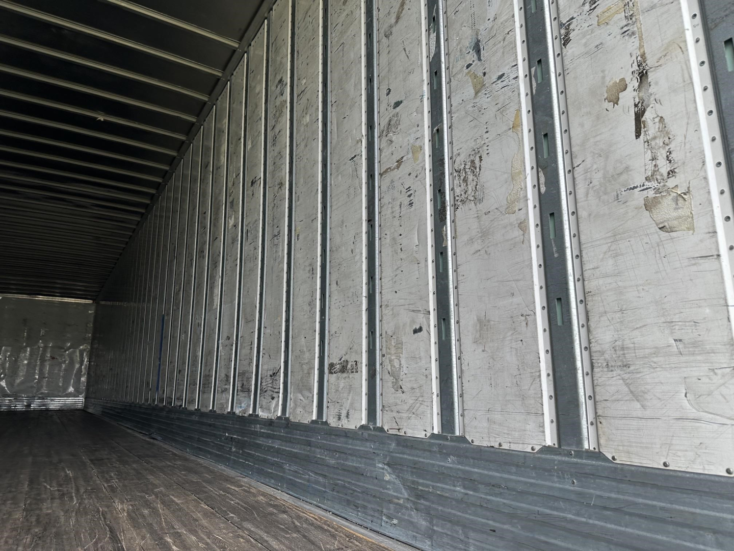 Trailer interior showing metal wall panels and ribbed floor in a 2016 Utility 4000D-X trailer