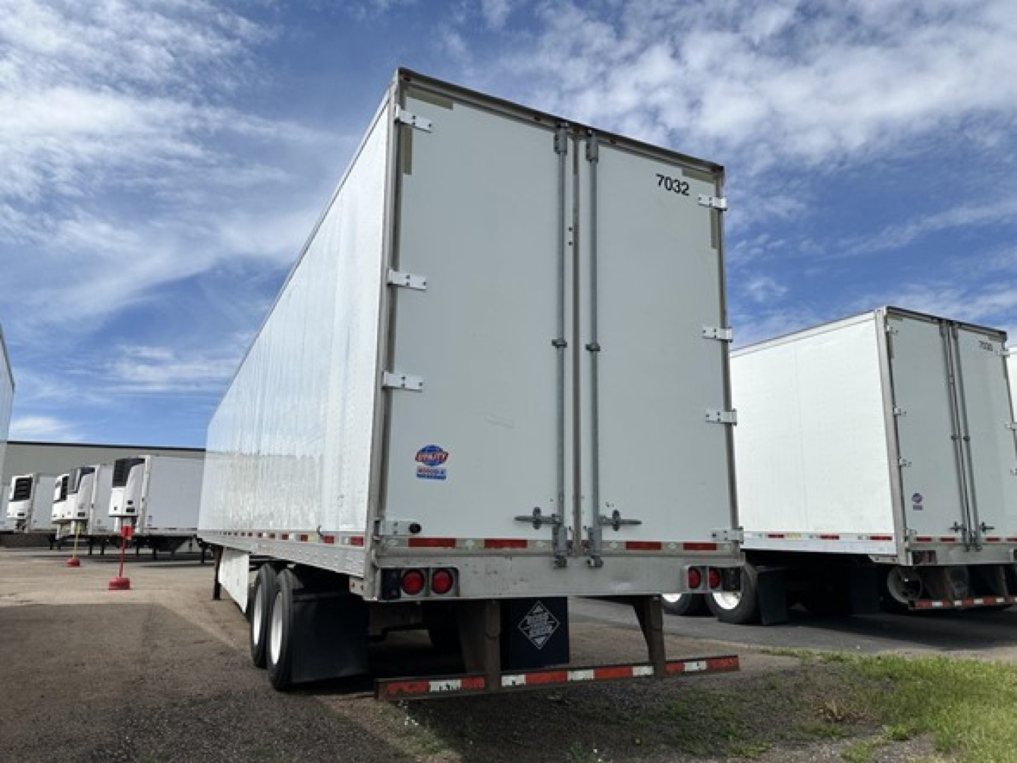 Rear/side view of a 2016 Utility 4000D-X trailer showing dual rear doors, license plate area, and rear lights.