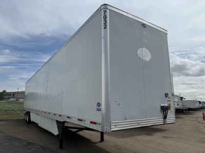 Trailer side and rear showing 2016 Utility 4000D-X trailer with raised front nose and rear doors.