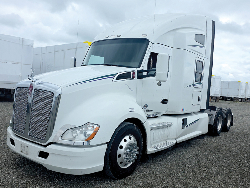 Kenworth T680 tractor, white, sleeper cab, side view with grille and front wheel, showing aerodynamic mirrors and cargo area.