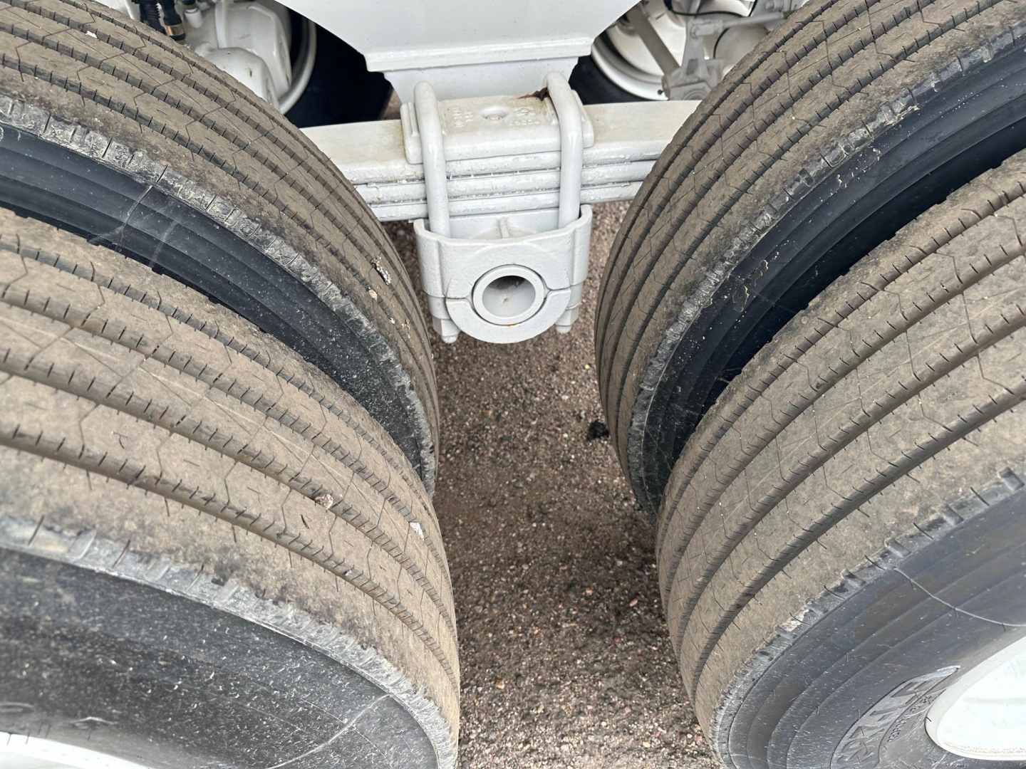 Trailer axles with dual rear tires and central hitch viewed from above
