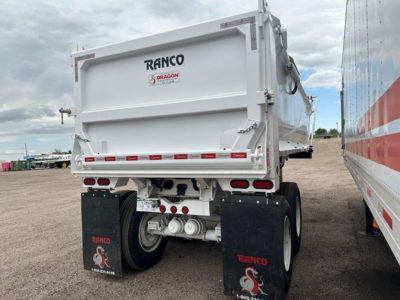 Ranco trailer rear view showing dump bed and dual axles with mud flaps and taillights.