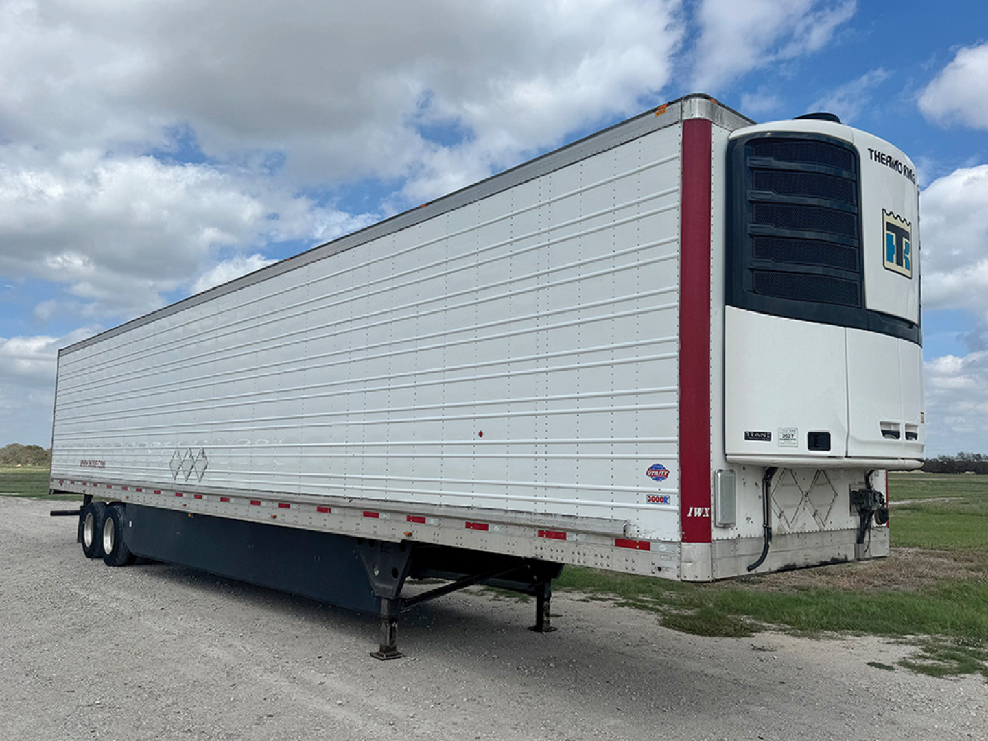 Utility 3000R refrigerated trailer in profile showing Thermo King unit on front, white riveted panels, dual rear doors, and support legs.