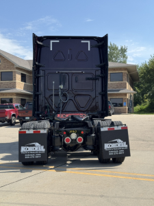 Rear view of a 2022 Freightliner Cascadia 126 truck showing dual rear mud flaps with 'KORDEL' branding and a black trailer chassis.
