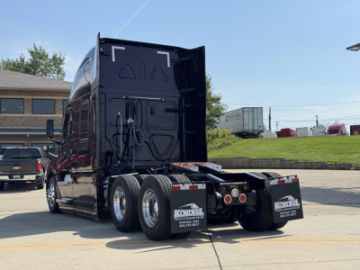 Semi truck rear view showing mud flaps with Kordell logo, dual rear axles, trailer hitch area, and truck body panels.