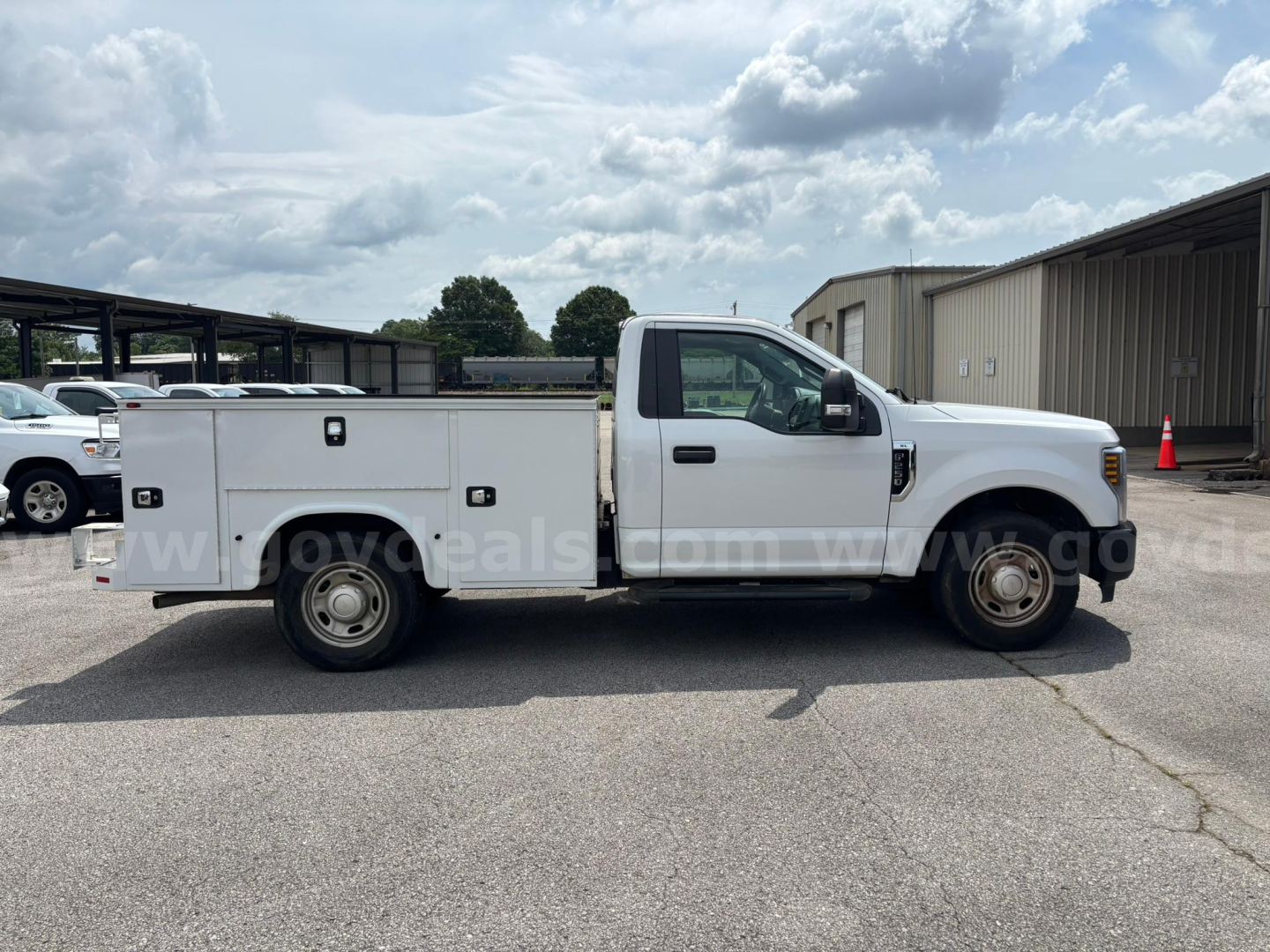 Ford F-250 service/utility truck side view showing utility boxes and cab in white, VIN 1FDBF2A63KEE67162 visible on listing.