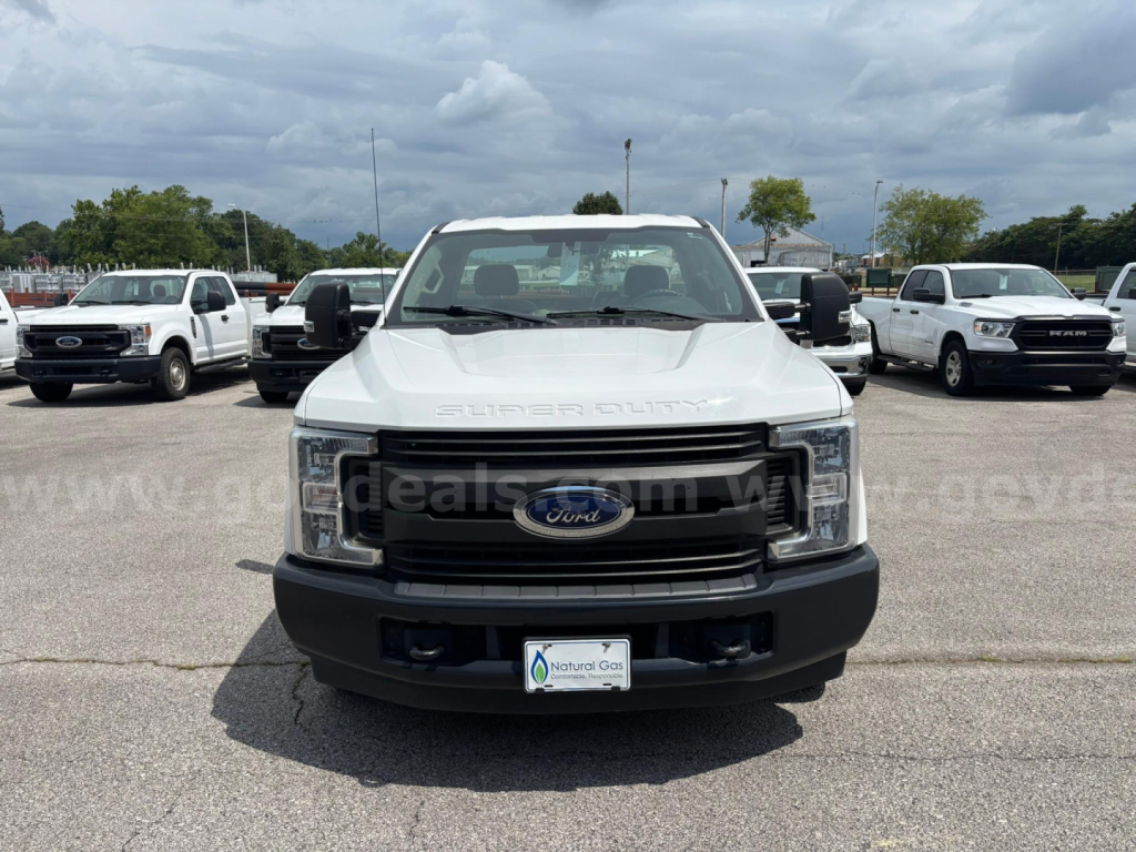 Ford F-250 Super Duty front view showing grille and Ford emblem in white truck, service/utility category used vehicle.