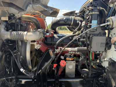 Engine bay of a 2020 Mack PI64T truck showing components, hoses, and wiring in view under hood.