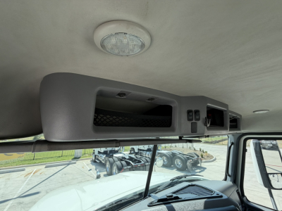 Cab interior showing overhead console with storage and control panels in a 2020 Mack PI64T truck, front windshield, ceiling dome light.