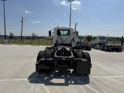 Truck chassis rear view showing fifth wheel and dual rear axles of a 2020 Mack PI64T in a parking lot.