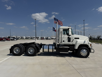 Mack PI64T heavy truck cab and chassis in profile view showing front cab and dual rear axle configuration.