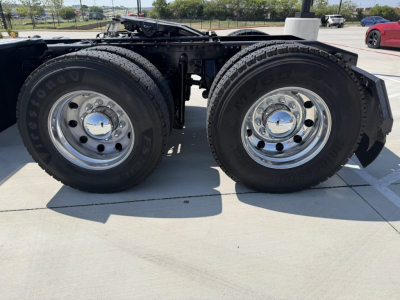 Rear tandem axle of a 2020 Mack PI64T truck showing twin rear wheels with polished chrome hubs and Hankook tires.