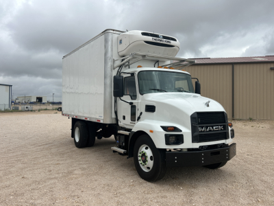 Truck cab in front view showing refrigerated box on a Mack MD6 with Thermo King unit on top.