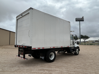 Truck rear and side view showing a white refrigerated box on a Mack MD6 chassis with modest cloud sky.