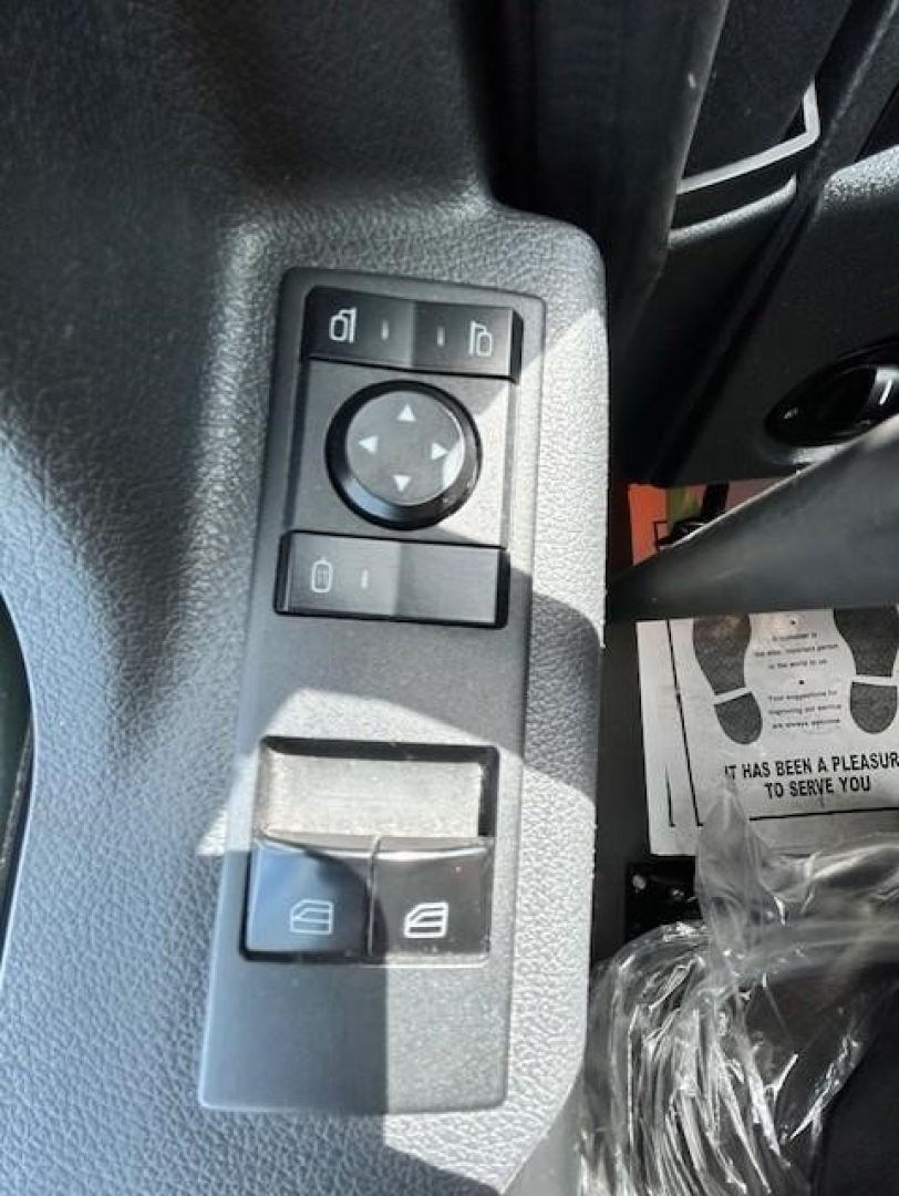 Truck interior control panel showing window/mirror adjustment buttons in a Freightliner Cascadia overhead console area.