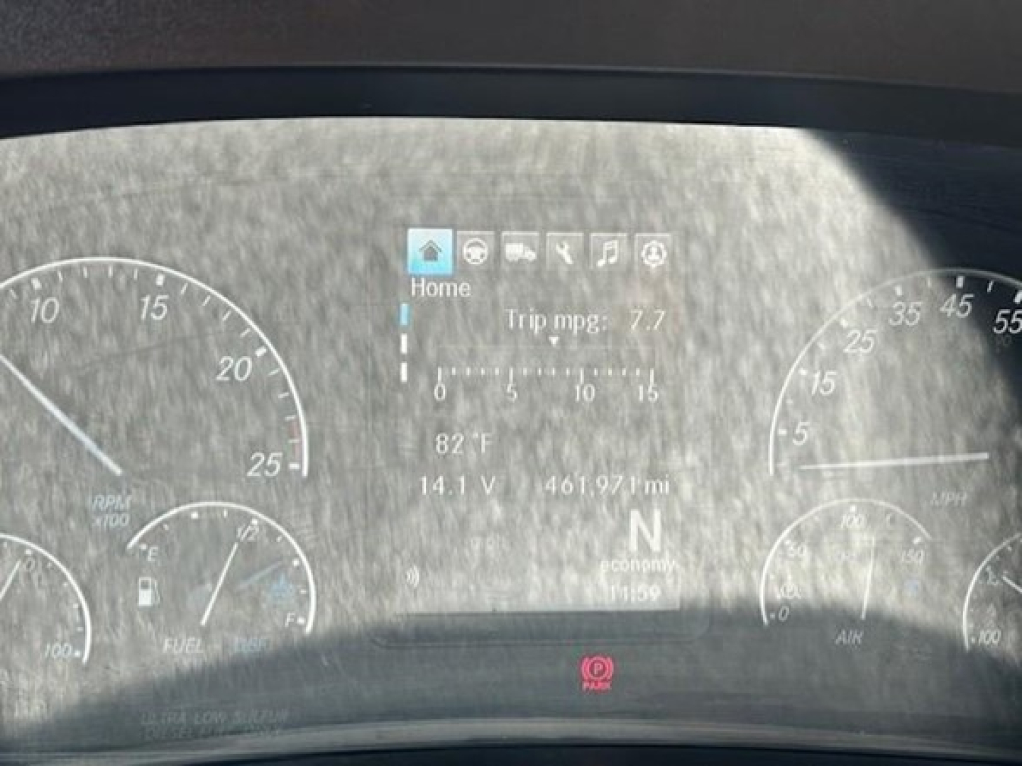Freightliner Cascadia dash showing trip mpg, engine gauges, and digital display with 82°F outside, 14.1V battery, 461.97 mi trip readout.