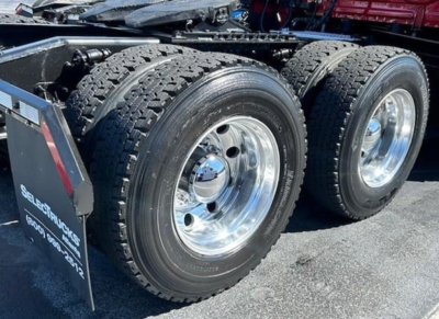 Freightliner Cascadia 126 tractor rear wheels and dual tires showing polished chrome rims.