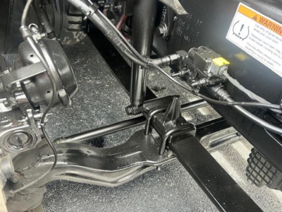 Freightliner Cascadia 126 cab chassis view showing steering column, suspension, and wiring harnesses under dash area.