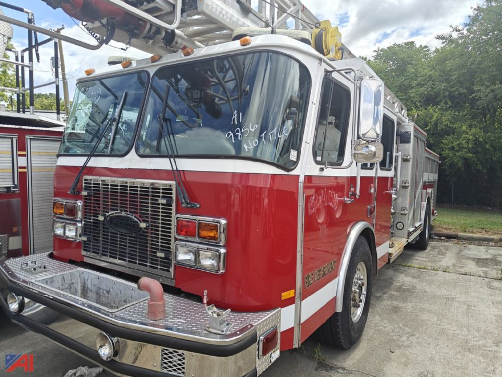Emergency One Quint fire engine showing front grille, bumper, and side compartments with red and white livery.