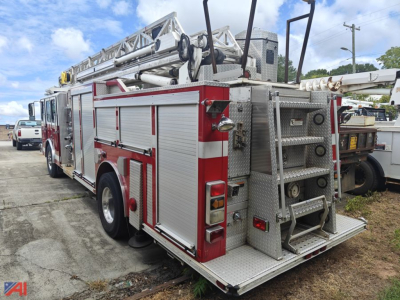 Emergency One quint fire truck rear view showing aluminum compartments and rear access ladder.