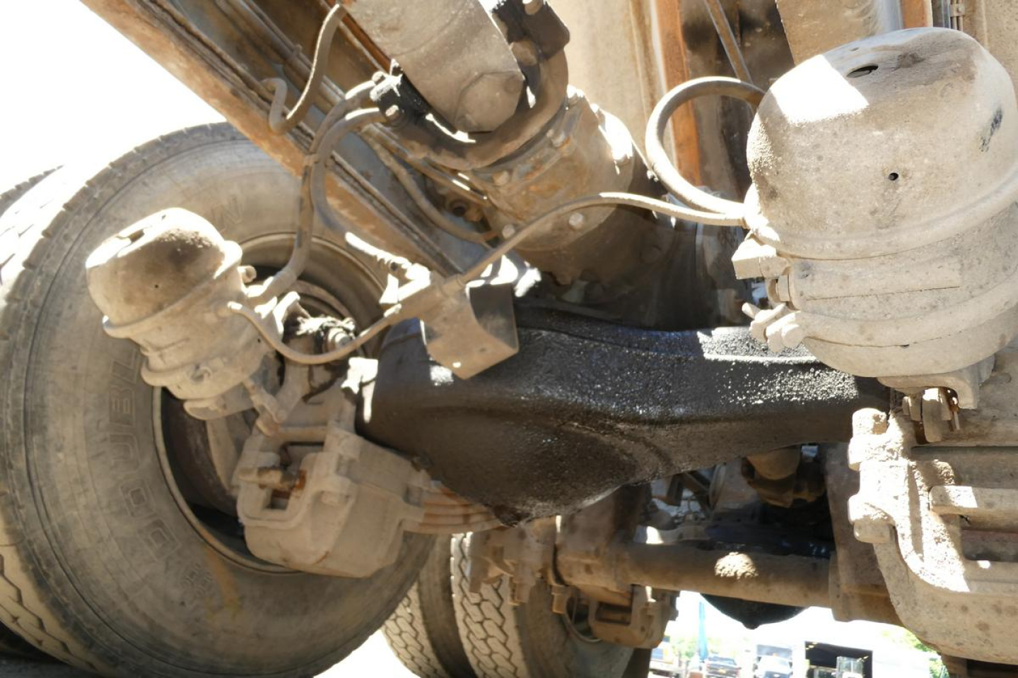 Mack RD688S front suspension and drivetrain components with axles, hoses, and brake assemblies visible.