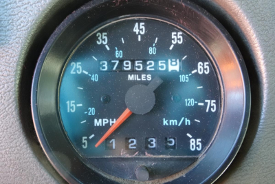 Dashboard odometer showing 379,525 miles and a speedometer scale in mph and km/h, with gear indicator 1-5 at bottom.