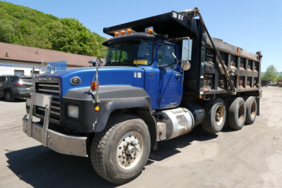 Mack RD688S dump truck in blue and black, three-axle with heavy-duty dump bed, front bumper guard, and dual fuel tanks visible.