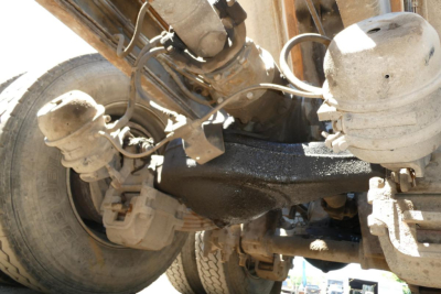 Mack RD688S front suspension and drivetrain components with axles, hoses, and brake assemblies visible.