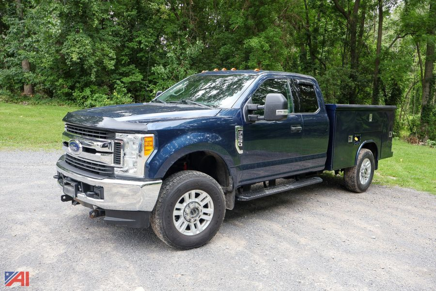 Ford F-350 Super Duty crew cab utility truck in blue, side view, with service bed.