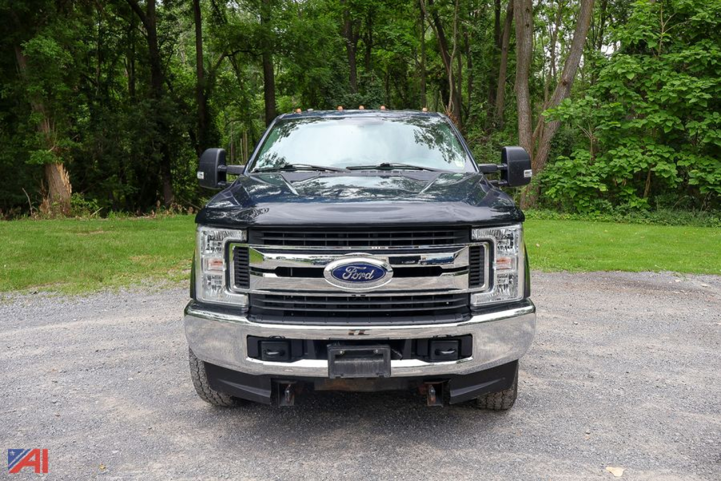 Ford F-Series Super Duty utility truck front view showing chrome grille, Ford emblem, daytime running lights, and large bumper.