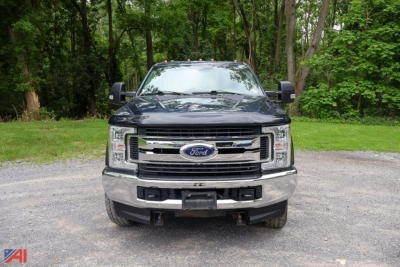 Ford F-Series Super Duty utility truck front view showing chrome grille, Ford emblem, daytime running lights, and large bumper.