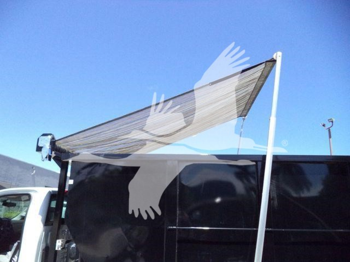 Chevrolet Silverado 6500HD rolloff truck with folded rear canopy and side paneling; stock number J05526FM; blue sky background.