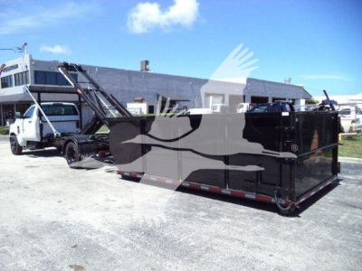 Truck with a roll-off container and crane in a lot; faint watermark superimposed. Visible text includes none legible; equipment appears to be a 2023 Chevrolet Silverado 6500HD stock photo context.