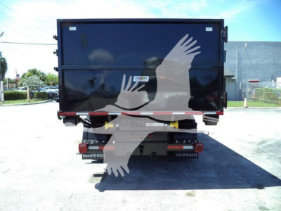 Truck dump bed section rear view showing solid black dump body with reflective taillights and bumper.