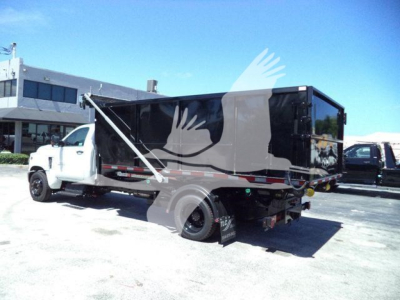 Truck-mounted dump body shows a 2023 Chevrolet Silverado 6500HD Rolloff configuration with a black dump bed, white cab, side decals, and rear hydraulic system visible.