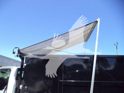 Chevrolet Silverado 6500HD rolloff truck with folded rear canopy and side paneling; stock number J05526FM; blue sky background.