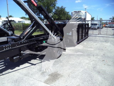 Truck equipment showing a black rollover bed with hydraulic arms and steel linkage, 2023 Chevrolet Silverado 6500HD stock image.