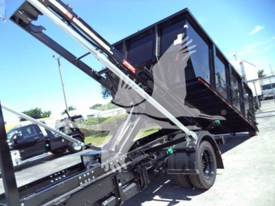 Truck chassis showing hydraulic arm and dump bed on a 2023 Chevrolet Silverado 6500HD in-service with a raised bed.