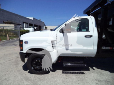 Chevrolet Silverado 6500HD pickup truck side view showing white cab and side steps.