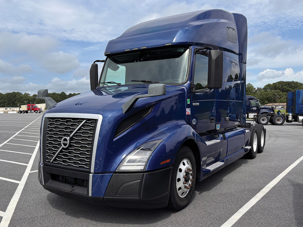 Volvo VNL 760 sleeper cab tractor in blue, front-left view, with high roof and large grille.